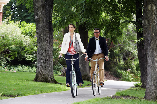 Andy Garcia and Vera Farmiga biking in a scene from 'At Middleton'