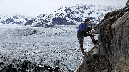 James Balog installing time-lapse camera on a cliff off Columbia Glacier
