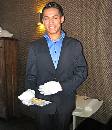 gentleman serving Lingot dOr de Foie Gras, a creamy goose liver accompanied by chopped almonds