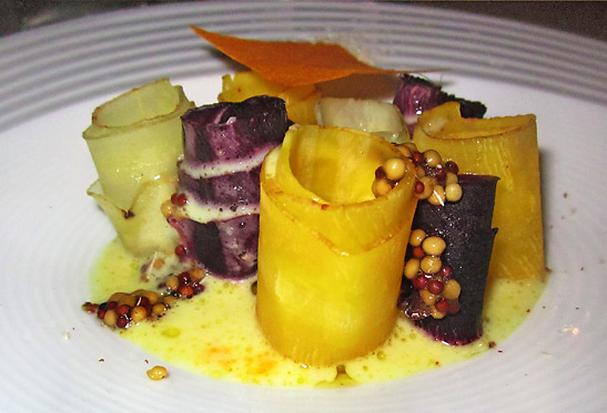 vegetable arrangement with bacon, fava beans, cheese, mustard seed sauce and pumpkin garni