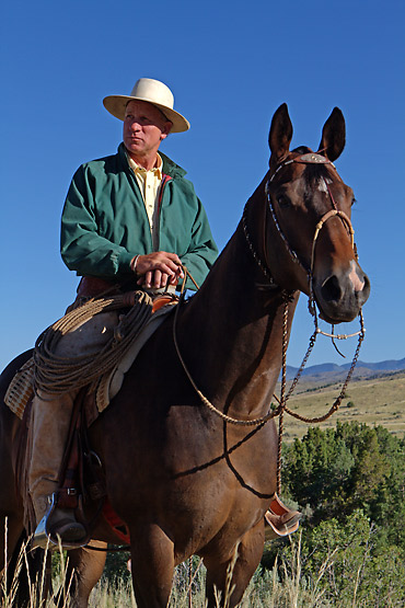 Buck Brannaman mounted on his horse