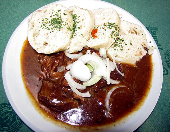 a plate of goulash and dumplings at a restaurant in Prague
