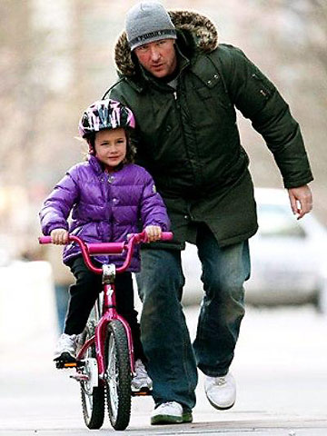 Edward Burns with daughter Grace on a bike