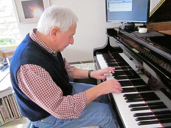 William Goldstein at the piano working on an instant composition
