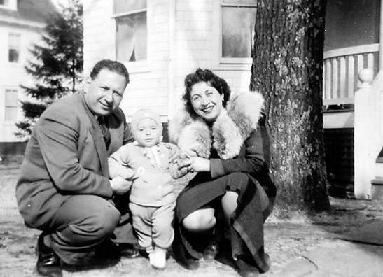 a young William Goldstein with his parents in front of their Lakewood NJ hotel in 1942