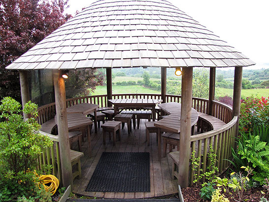 a gazebo overlooks lush, rolling countryside of the Castle Leslie Estate, Ireland