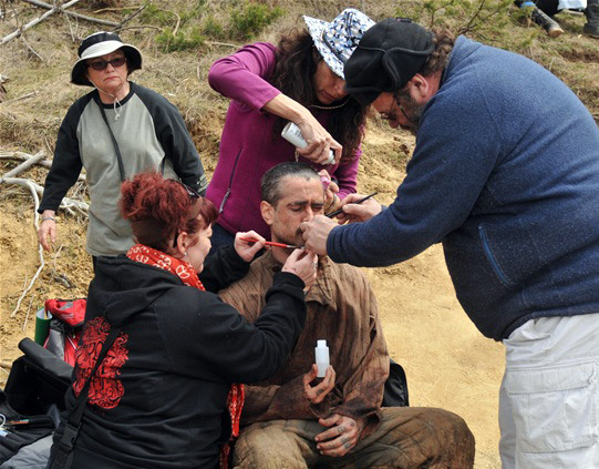 Crew applying make-up on Colin Farrell