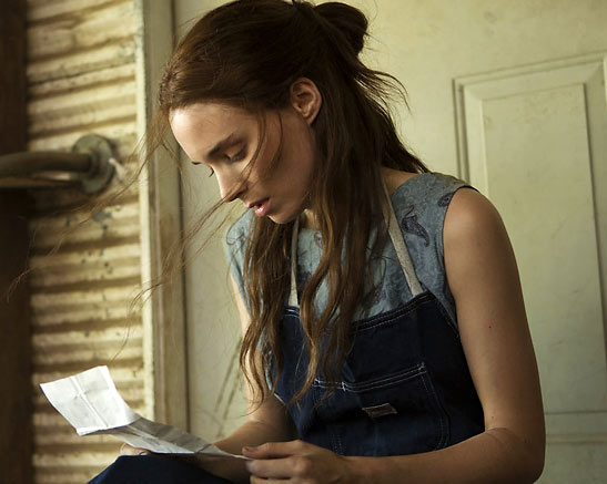 Rooney Mara reading a letter in a scene from 'Ain't Them Bodies Saints'