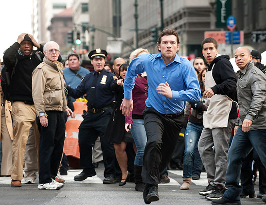 Sam Worthington pursuing a fugitive in street scene from 'Man On a Ledge'