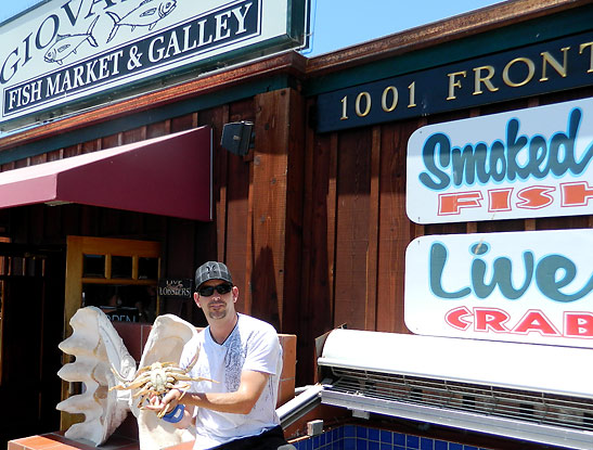 Giovanni DeGarimore with a live crab at his Stax and Giovanni's Fish Market and Galley