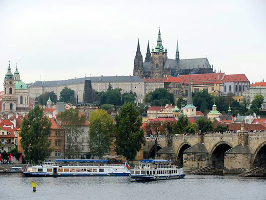 the Charles Bridge and the Vitava River with the St. Vitus Church and Prague Palace in the background