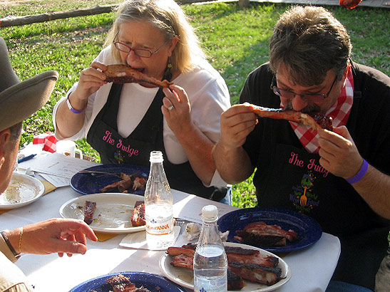 judges sampling barbecued ribs at the annual barbecue cook-off, Rio Cabilo cattle ranch, Texas