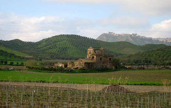 one of the deserted and crumbling old stone buildings in the fields of southern Italy