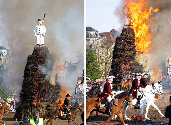 snowman being burned as guild members on horseback ride in circles around burning effigy