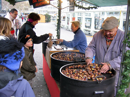 vendors selling roasted chestnuts at a Christmas market in Geneva, Switzerland