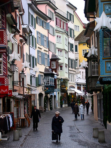 holiday decorations on buildings along a street in Zurich