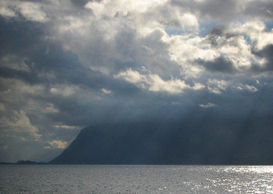 storm clouds shrouding the mountains along Lake Geneva: a view from the train between Montreux and Geneva