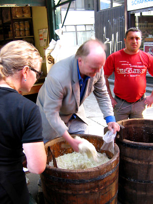 the Sauerkraut Man serving his product from a 30 gallon barrel, Naschmarkt, Vienna