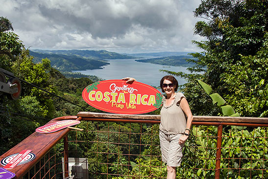 visitor with Greetings from Costa Rica sign