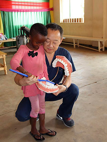 Dr. Lee teaching a young Rwandan how to care for