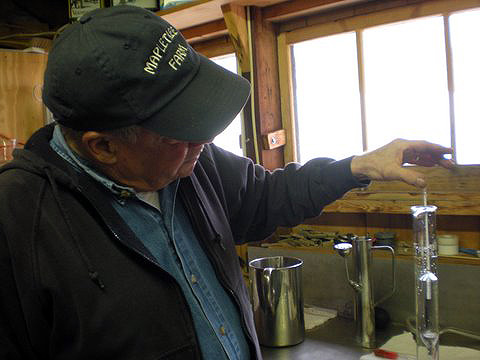 Dean Wiber with sample bottles of maple syrup, Mapletree Farm