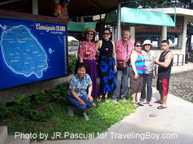 the writer and friends at resort's front office with a map of Camiguin