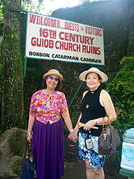 writer and friend at the entrance to the San Roque Church ruins, Gui-Ob, Camiguin