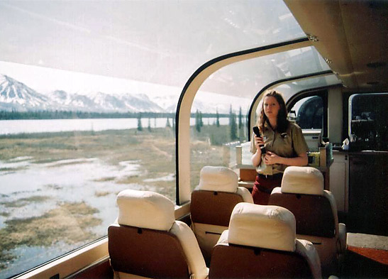 aa tour guide briefs visitors on board a glass-domed Wilderness Express traincar to Denali National Park