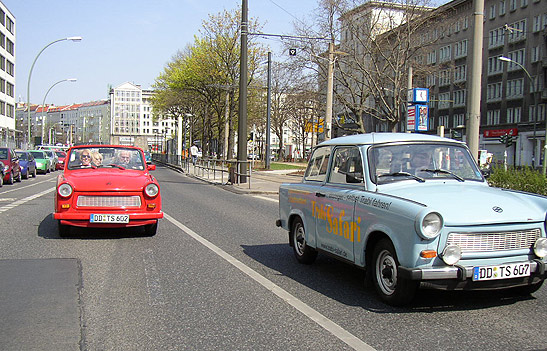 a red and blue Trabant on a Berlin street