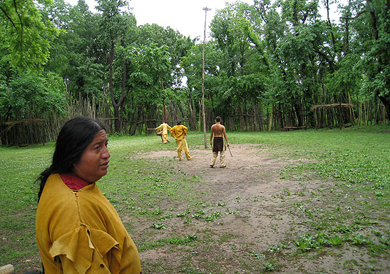 Cherokee guide showing field game being played by tribe members at the Ancient Village, Cherokee Nation