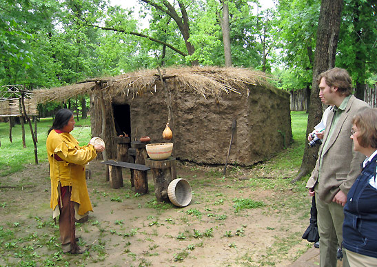 Cherokee guide showing basket crafts to visitors at the Ancient Village, Cherokee Nation, Tahlequah, Oklahoma