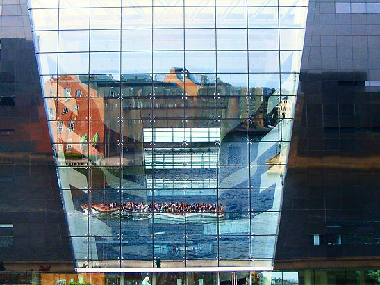a view through a glass section of the Black Diamond, a new building for the Royal Library, Copenhagen