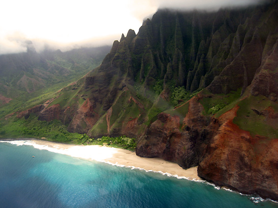 view from helicopter of Waimea Canyon with a white sandy beach