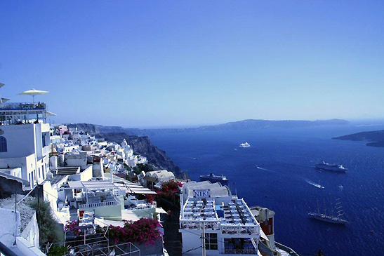 whitewashed houses perched on cliff overlooking caldera, Santorini