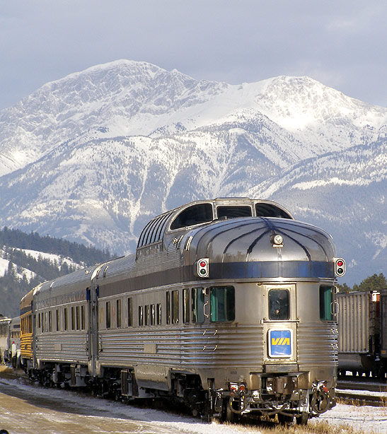 VIA Rail train with the Canadian Rockies in the background