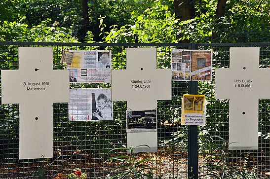 wire fence with names and pictures of people killed trying to escape East Germany