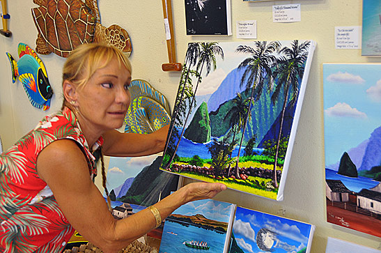 Ani Van Eps with paintings at the Molokai Art from the Heart gallery