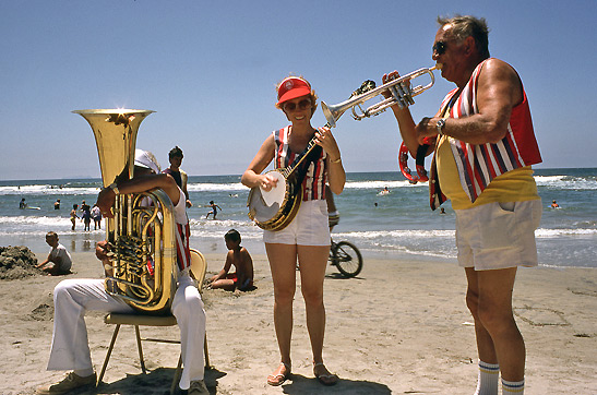 three musicians on a beach in San Diego