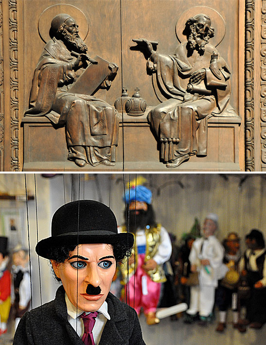 wood carving of religious figures and a Charlie Chaplin puppet