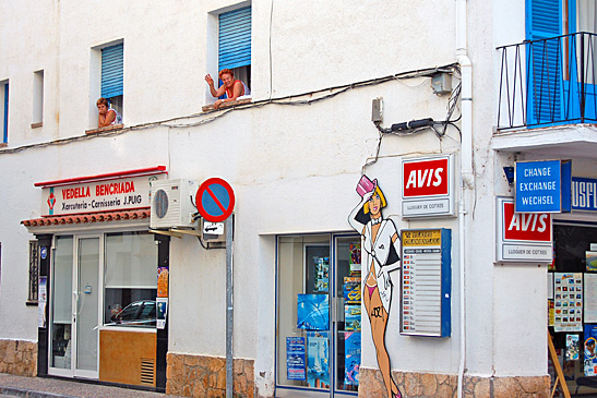 locals looking out from windows, street in Tossa de Mar