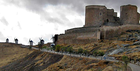 medieval castle once the stronghold of the Knights of San Juan with windmills in the background, Consuegra