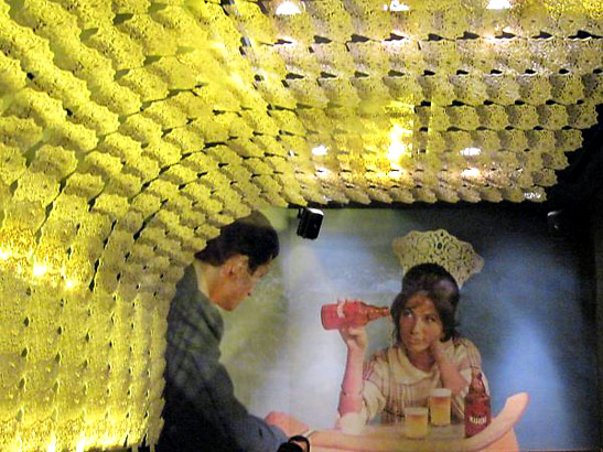 hundreds of traditional Spanish hair combs form an arch decor on the ceiling of the Estado Puro restaurant alongside a mural of woman wearing a similar hair comb