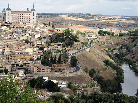 view of the ancient walled city of Toledo from a nearby hilltop
