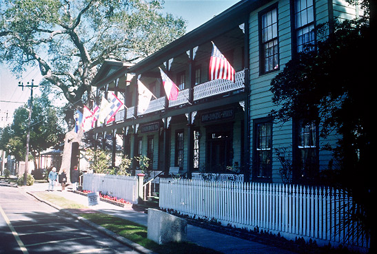building displaying seven flags of states that have ruled over Amelia Island