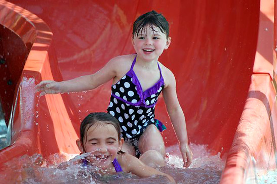 Ellie and Talya coming down a slide at Reunion Resort's Lazy River, Orlando, River