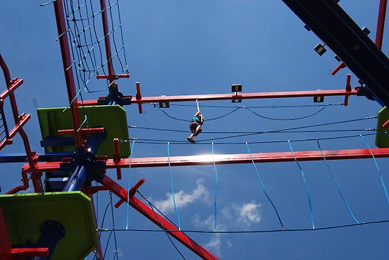 Ellie traversing the outdoor ropes course at Old Town, Orlando