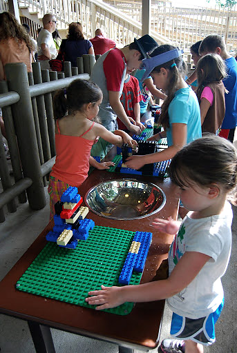 Becca, Ellie and Talya play with Legos while their parents wait in line for the next ride, Legoland