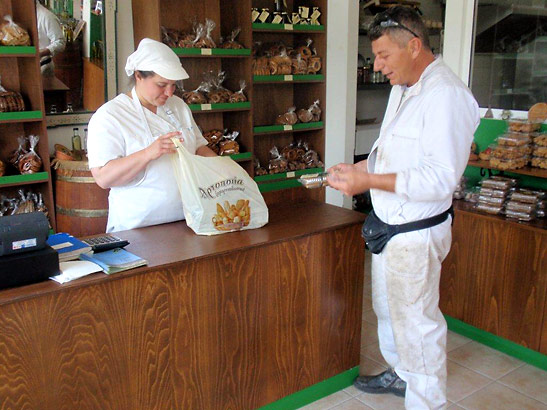 waiting on a customer at the Appolonia Bakery