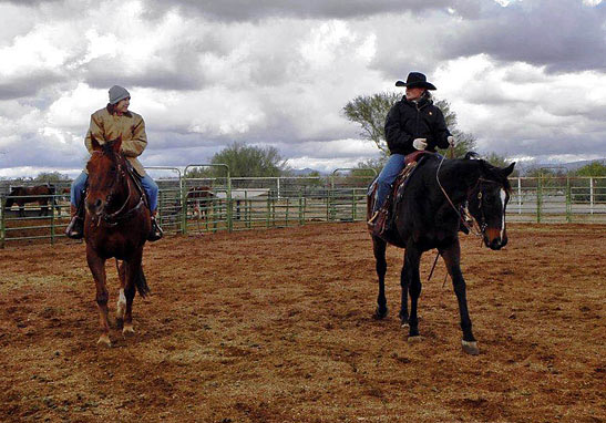 writer riding horse inside corral with ranch manager Elaine Pawlowski, Arizona Cowboy College, Scottsdale