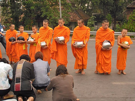 Buddhist monks in familiar orange robes, Thailand